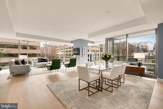dining space featuring wood finished floors and floor to ceiling windows