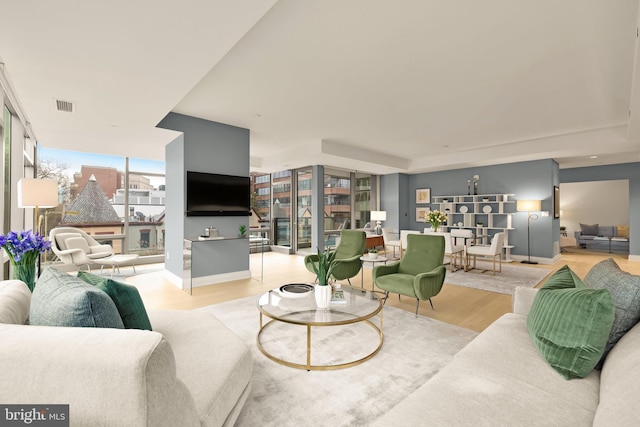 living room featuring wood finished floors and baseboards
