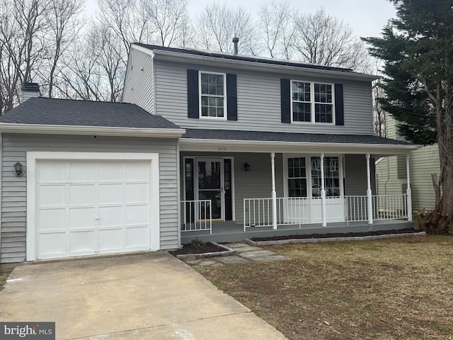 view of front of property with driveway, an attached garage, and a porch