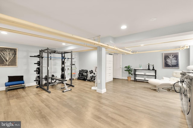 exercise area with recessed lighting, baseboards, and light wood-style floors
