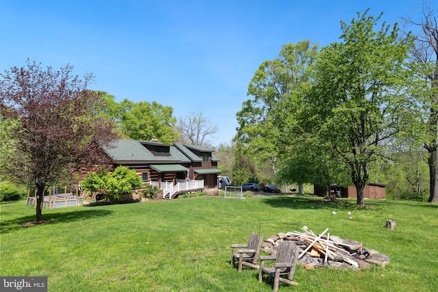 view of yard with an outdoor fire pit