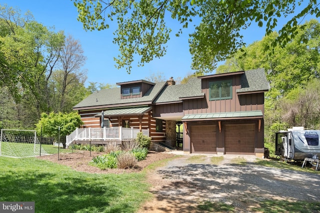 log-style house with board and batten siding, a chimney, dirt driveway, a garage, and a shingled roof
