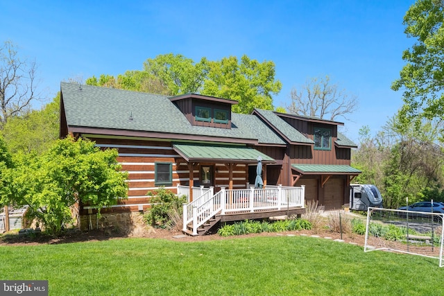 view of front of house featuring roof with shingles, an attached garage, a front lawn, board and batten siding, and covered porch