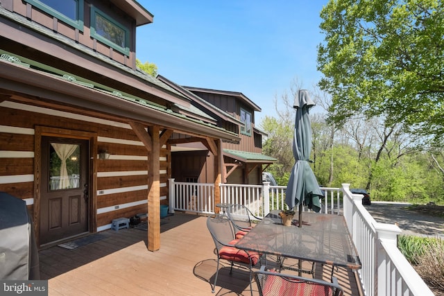 wooden terrace with outdoor dining space