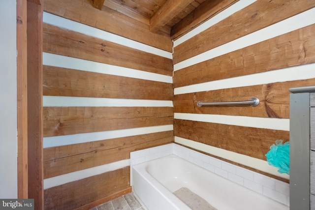 bathroom featuring a tub to relax in, wood ceiling, and wooden walls