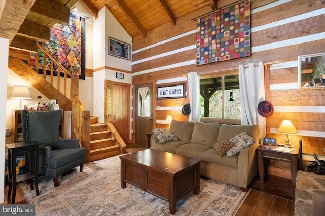 living area featuring wood ceiling, hardwood / wood-style flooring, stairway, high vaulted ceiling, and beamed ceiling