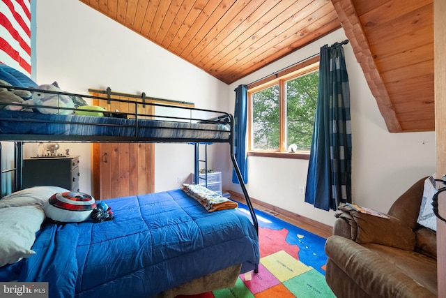 bedroom featuring baseboards, wood ceiling, wood finished floors, and vaulted ceiling