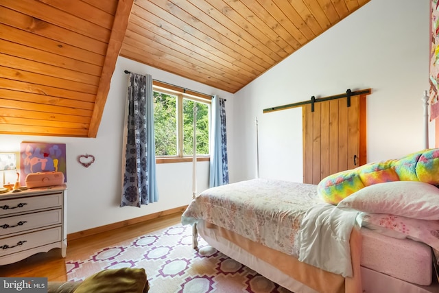 bedroom featuring a barn door, baseboards, wood finished floors, vaulted ceiling, and wood ceiling