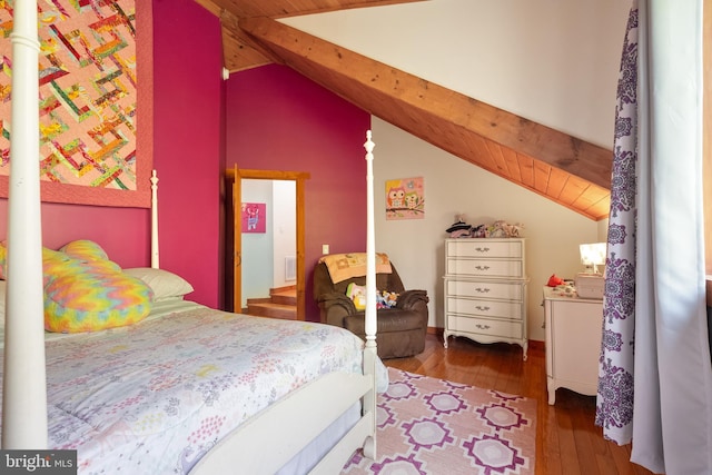 bedroom featuring vaulted ceiling with beams, wood-type flooring, visible vents, and wooden ceiling
