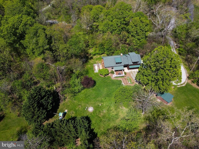birds eye view of property featuring a view of trees