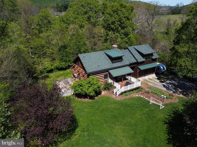 birds eye view of property featuring a view of trees
