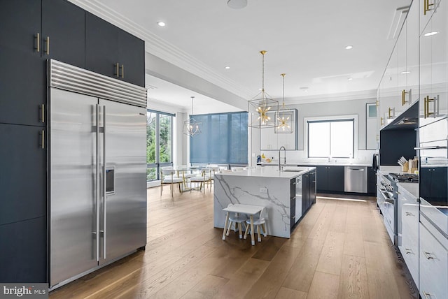 1109 Towlston Rd, Mclean, VA 22102 - kitchen with an inviting chandelier, a sink, a kitchen island with sink, high end appliances, and ornamental molding