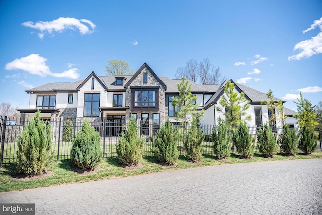 1109 Towlston Rd, Mclean, VA 22102 - view of front of house with a fenced front yard, stucco siding, and stone siding