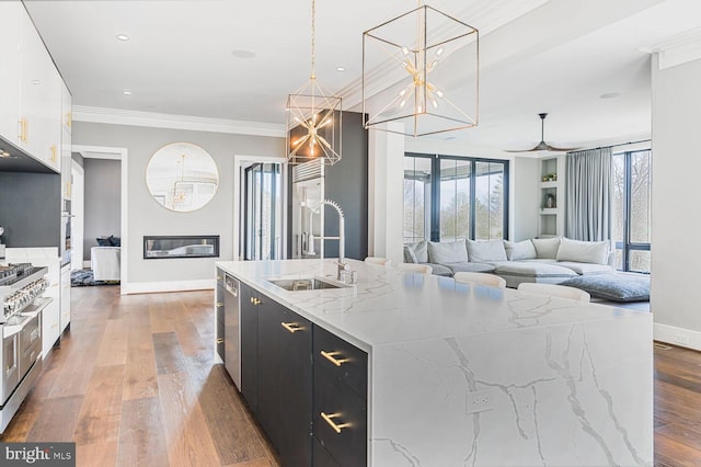 1109 Towlston Rd, Mclean, VA 22102 - kitchen with white cabinets, a sink, dark cabinets, baseboards, and a center island with sink