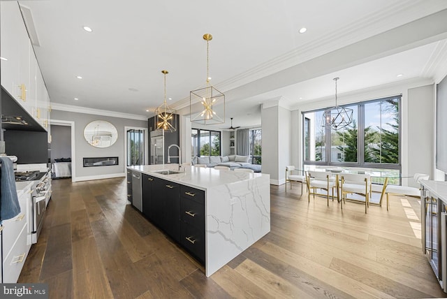 1109 Towlston Rd, Mclean, VA 22102 - kitchen with an inviting chandelier, a large island with sink, dark cabinetry, a sink, and high end stainless steel range oven