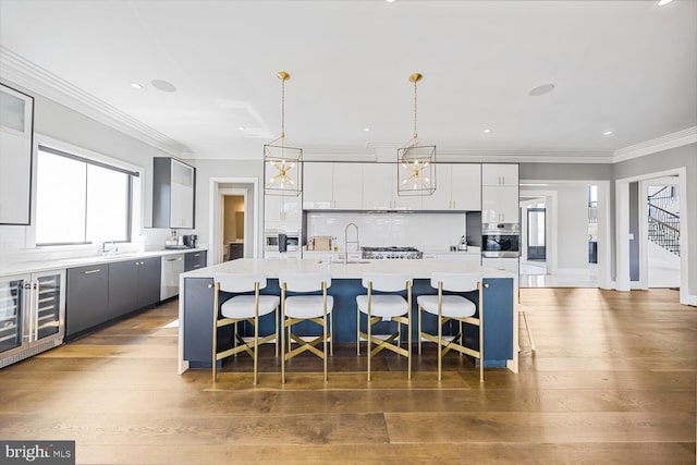 1109 Towlston Rd, Mclean, VA 22102 - kitchen featuring light countertops, stainless steel appliances, a wealth of natural light, and a kitchen bar