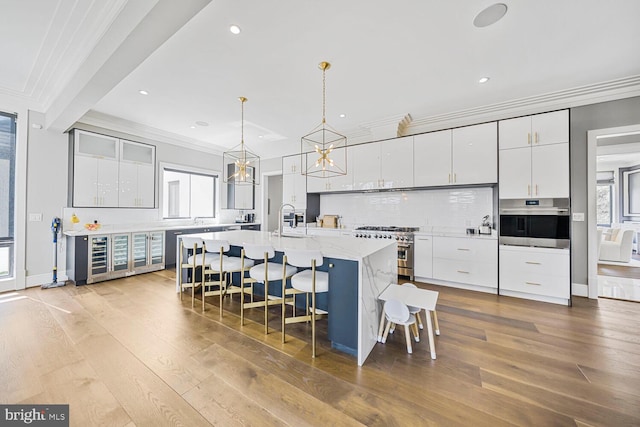 1109 Towlston Rd, Mclean, VA 22102 - kitchen with crown molding, wood-type flooring, stainless steel appliances, and a sink