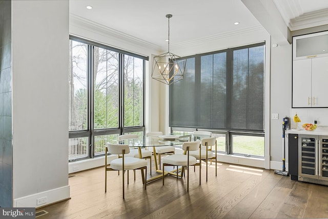 1109 Towlston Rd, Mclean, VA 22102 - dining area featuring ornamental molding, wine cooler, wood finished floors, baseboards, and a chandelier