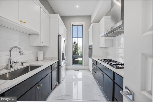 1109 Towlston Rd, Mclean, VA 22102 - kitchen featuring white cabinets, a sink, wall chimney exhaust hood, stainless steel appliances, and tasteful backsplash