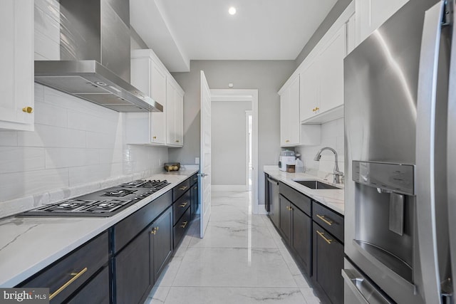 1109 Towlston Rd, Mclean, VA 22102 - kitchen featuring appliances with stainless steel finishes, a sink, marble finish floor, wall chimney exhaust hood, and white cabinetry