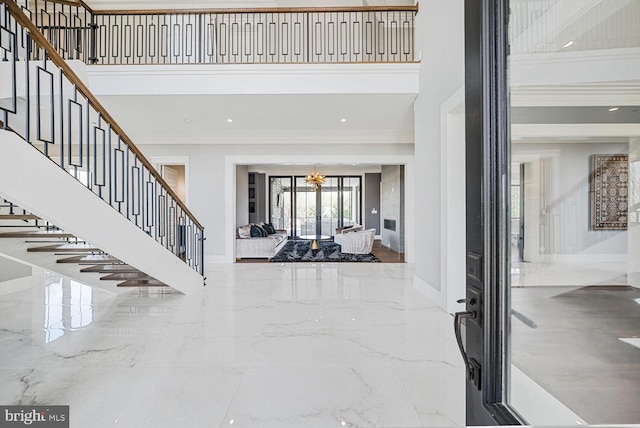 1109 Towlston Rd, Mclean, VA 22102 - foyer entrance with crown molding, baseboards, stairway, and a towering ceiling