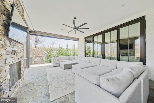 1109 Towlston Rd, Mclean, VA 22102 - living area with plenty of natural light, a ceiling fan, stone finish flooring, and expansive windows