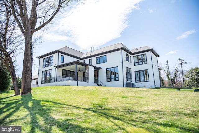 1109 Towlston Rd, Mclean, VA 22102 - back of house with central AC, a ceiling fan, stucco siding, and a yard