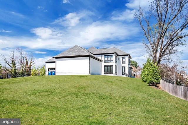 1109 Towlston Rd, Mclean, VA 22102 - view of front facade with stucco siding, fence, and a front lawn