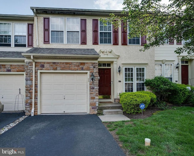 62 Brookview Ln, Pottstown, PA 19464 - view of property featuring a garage, stone siding, driveway, and stucco siding