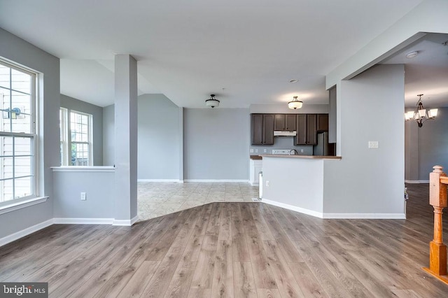 62 Brookview Ln, Pottstown, PA 19464 - unfurnished living room with light wood-type flooring and a chandelier