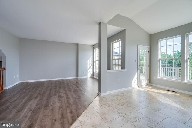 62 Brookview Ln, Pottstown, PA 19464 - unfurnished living room featuring arched walkways and lofted ceiling