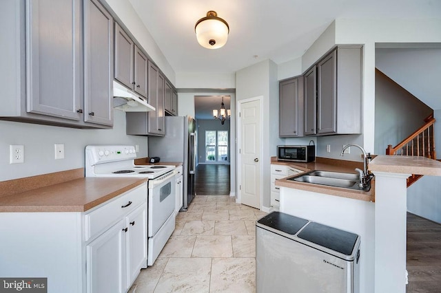 62 Brookview Ln, Pottstown, PA 19464 - kitchen featuring white range with electric cooktop, stainless steel microwave, under cabinet range hood, gray cabinets, and a peninsula