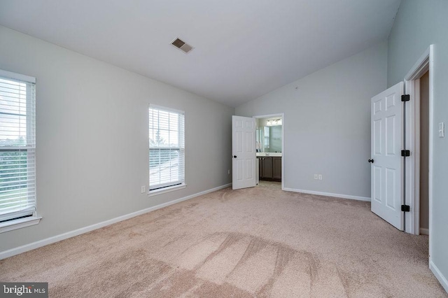 62 Brookview Ln, Pottstown, PA 19464 - unfurnished bedroom with lofted ceiling, light colored carpet, and connected bathroom