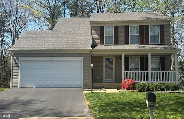 view of front of property with covered porch, aphalt driveway, a garage, a front lawn, and a shingled roof