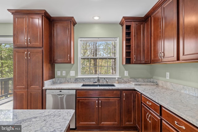 kitchen featuring stainless steel dishwasher, dark brown cabinets, light stone countertops, recessed lighting, and a sink