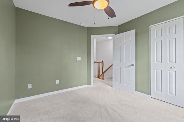 unfurnished bedroom with carpet floors, baseboards, visible vents, and a closet