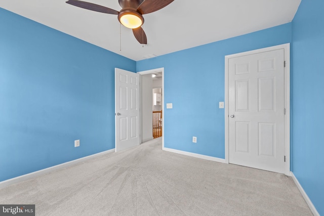 unfurnished bedroom with carpet floors, baseboards, and ceiling fan