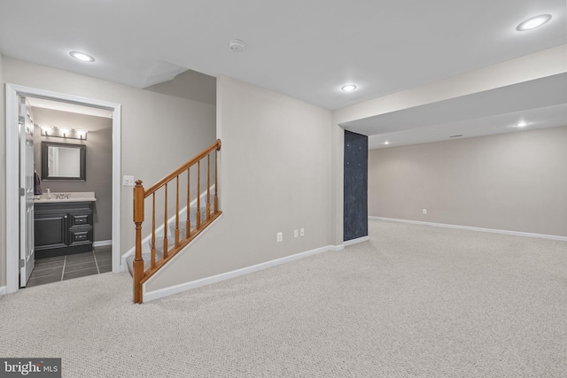 finished basement with baseboards, carpet, and stairs