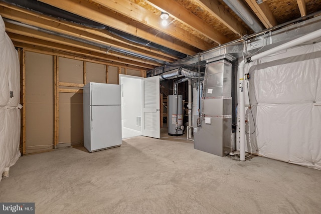 unfinished below grade area featuring freestanding refrigerator, heating unit, visible vents, and gas water heater