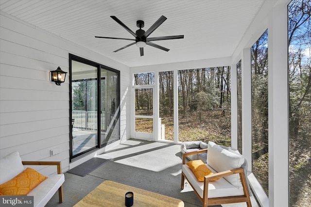 sunroom / solarium featuring ceiling fan