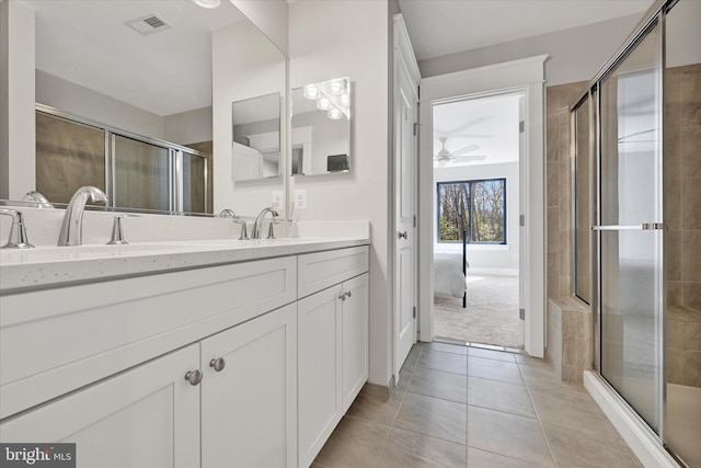 bathroom featuring ceiling fan, a stall shower, and tile patterned floors