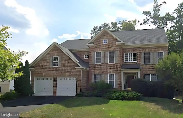 18547 Kerill Rd, Triangle, VA 22172 - colonial house featuring brick siding, a garage, asphalt driveway, and a front yard