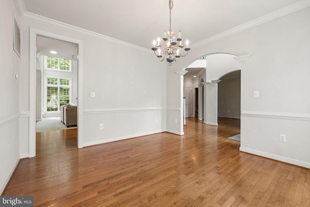 18547 Kerill Rd, Triangle, VA 22172 - unfurnished room featuring arched walkways, ornate columns, wood finished floors, ornamental molding, and a chandelier
