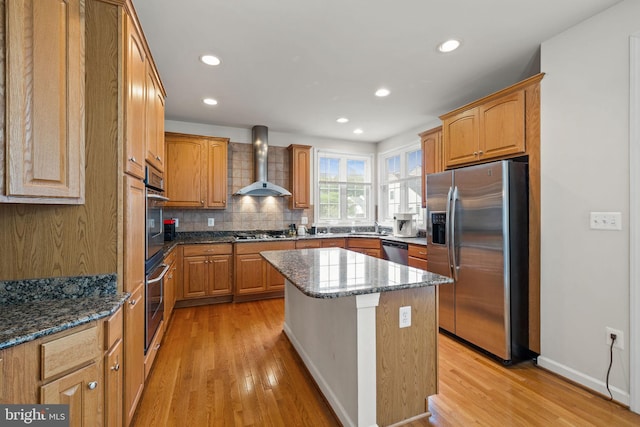 18547 Kerill Rd, Triangle, VA 22172 - kitchen featuring stainless steel appliances, wall chimney range hood, light wood-style flooring, tasteful backsplash, and recessed lighting