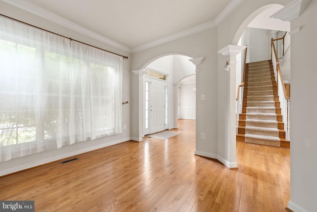 18547 Kerill Rd, Triangle, VA 22172 - entrance foyer with arched walkways, hardwood / wood-style floors, crown molding, stairs, and baseboards