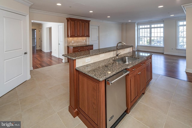 kitchen featuring backsplash, ornamental molding, a sink, and stainless steel dishwasher