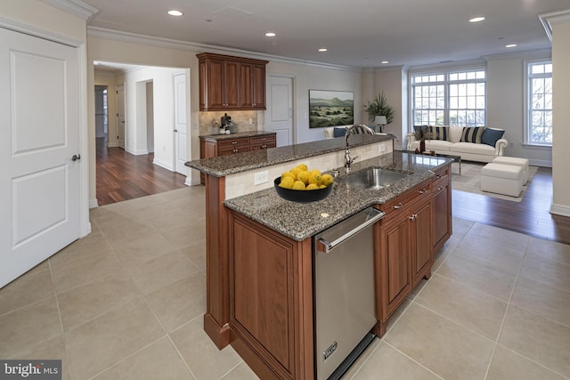 kitchen featuring a sink, crown molding, and stainless steel dishwasher
