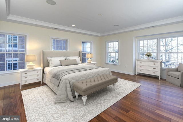 bedroom with ornamental molding, visible vents, and dark wood finished floors