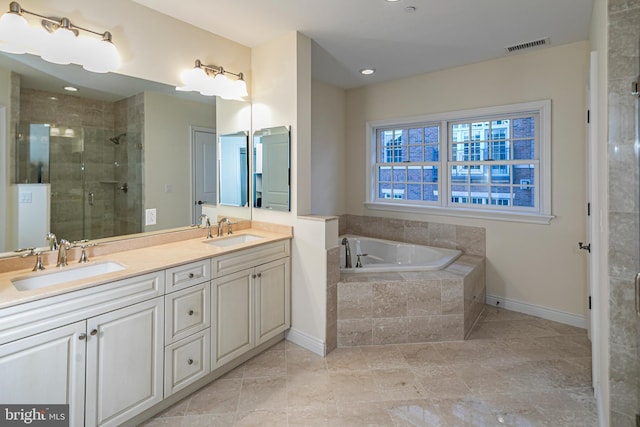 full bathroom featuring double vanity, a sink, a stall shower, and visible vents