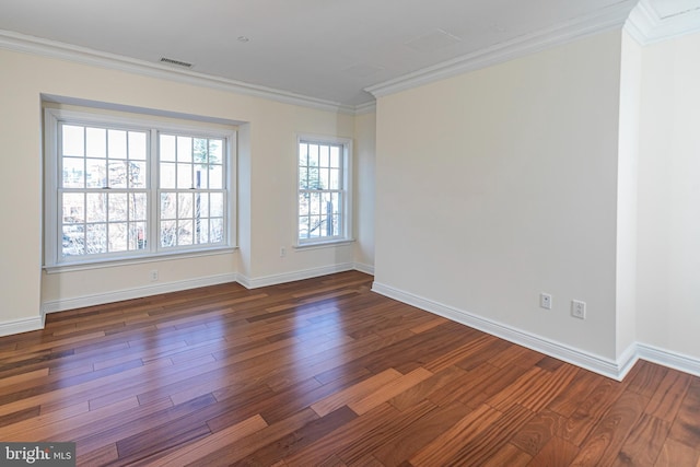 unfurnished room featuring baseboards, visible vents, wood finished floors, and crown molding